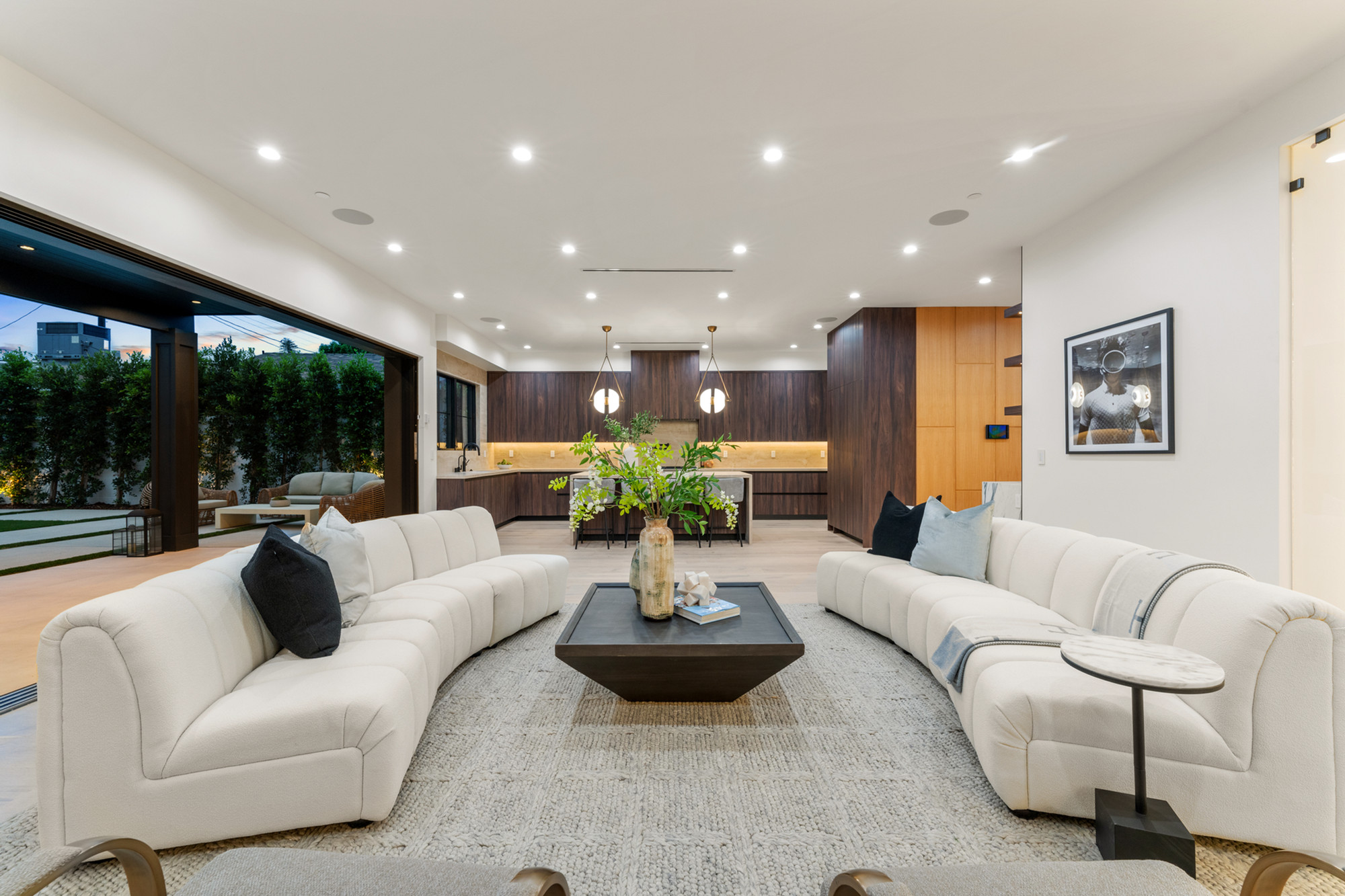 Living room opening to kitchen, wall-to-wall walnut